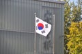 Korean National flag Taegeukgi flies in front of the building in the park in Autumn