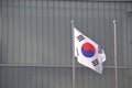 Korean National flag Taegeukgi flies in front of the building in the park in Autumn