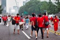 Korean people in red on street for festivity event Royalty Free Stock Photo