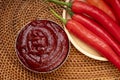 Korean pepper paste and red pepper in wooden plate, Gochujang Korean traditional Chili paste on a wooden table background.