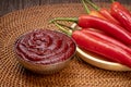 Korean pepper paste and red pepper in wooden plate, Gochujang Korean traditional Chili paste on a wooden table background.