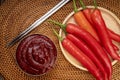 Korean pepper paste and red pepper in wooden plate, Gochujang Korean traditionl Chili paste on a wooden table background.