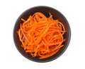 Korean pickled carrots salad in black bowl isolated on white background. top view