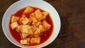 Korean Radish Kimchi in white bowl on wood table for food content Royalty Free Stock Photo