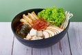 Korean Ramen Spicy Miso with pork, egg and mushroom, vegetables in a blue bowl on wooden table Royalty Free Stock Photo