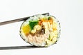 Korean roll gimbap and chopsticks on white background close-up. Royalty Free Stock Photo