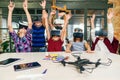 Korean scientist with the group of young pupils with laptop and VR headsets during a computer science class. Excited Royalty Free Stock Photo