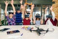 Korean scientist with the group of young pupils with laptop and VR headsets during a computer science class. Excited Royalty Free Stock Photo