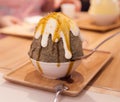 Korean shaved ice or snow cone bingsu or bingsoo dessert, Japanese Tea Matcha flavored with condensed milk and sweet caramel