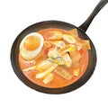 Korean spicy rice cakes with an egg in laksa sauce in a frying pan served hot Royalty Free Stock Photo