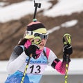 Korean sportswoman biathlete Yu Seolhee skiing distance biathlon complex after rifle shooting. Open regional youth