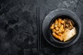 Korean street food Tteokbokki, Topokki fried rice cake stick in spicy sauce. Black background. Top view. Copy space Royalty Free Stock Photo