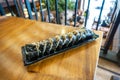 Korean sushi rolls (kimbap or gimbap) are cut into small pieces and served on a long plate