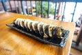 Korean sushi rolls (kimbap or gimbap) are cut into small pieces and served on a long plate