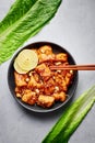 Korean Sweet Fried Chicken Dakgangjeong in black bowl at grey concrete table top. Korean Food Royalty Free Stock Photo