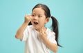 Korean sweet little girl cleaning his teeth with a dental floss on blue isolated. Royalty Free Stock Photo