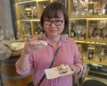 Korean tourist enjoying a sample of Czech cuisine on a food tour for tourists, Prague, Czech Republic Royalty Free Stock Photo