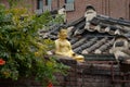 Korean traditional architecture. Golden Buddha statue on a roof Royalty Free Stock Photo