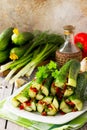 Korean traditional food Kimchi Cucumber. Marinated cucumbers with vegetable filling sweet pepper, garlic, onion, greens, tomato Royalty Free Stock Photo