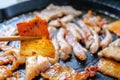Korean traditional grilled BBQ food, samgyupsal, pork with gochujang and Grilled Pork Neck on hot pan, Food for camping in winter Royalty Free Stock Photo