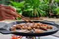 Korean traditional grilled BBQ food, samgyupsal, pork with gochujang and Grilled Pork Neck on hot pan, Food for camping in winter Royalty Free Stock Photo