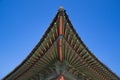 Korean traditional roof with blue sky background. Royalty Free Stock Photo