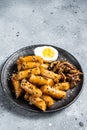 Korean Tteokbokki, Topokki fried rice cake stick in Hot and spicy sauce. Gray background. Top view Royalty Free Stock Photo