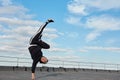 Korean urban style male dancer performing breakdance handstand on top roof Royalty Free Stock Photo