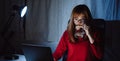 Korean woman working late time with laptop computer drinking water home office workhard overworked Royalty Free Stock Photo