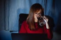 Korean woman working late time with laptop computer drinking water home office workhard overworked Royalty Free Stock Photo