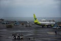 Korean worker people airline ground staff working prepare boeing plane take off flying to sky on runway while raining storm at