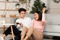 Korean Young Couple Playing Video Games In Living Room
