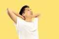 Korean young man`s half-length portrait on yellow background Royalty Free Stock Photo