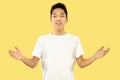 Korean young man`s half-length portrait on yellow background Royalty Free Stock Photo