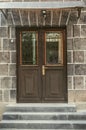 Black double leaf iron door covered with wrought iron decorative grating on the facade of a stone building Royalty Free Stock Photo