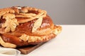 Korovai on white table, space for text. Ukrainian bread and salt welcoming tradition