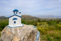 Small white blue church on a rock near village of Zia on the island Kos in Greece