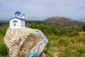 Small white blue church on a rock near village of Zia on the island Kos in Greece