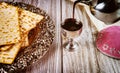 Kosher kiddush, matza and kippa on wooden background