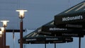 Kostanay, Kazakhstan, Friday July 13, 2018, McDonald`s inscription and logo and burning street lights.