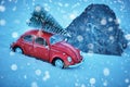 Kostanay, Kazakhstan 2022. Red Volkswagen beetle in snowy weather with spruce on roof, stuck in snow Royalty Free Stock Photo