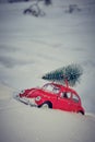 Kostanay, Kazakhstan 2022.Red Volkswagen beetle with spruce on roof, against background white snow Royalty Free Stock Photo
