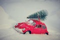 Kostanay, Kazakhstan 2022.Red Volkswagen Beetle With Spruce On Roof, Against Background White Snow