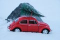 Kostanay, Kazakhstan 2022.Red Volkswagen beetle with spruce on roof stuck in snow Royalty Free Stock Photo