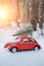 Kostanay, Kazakhstan 2022.Red Volkswagen beetle with a spruce on roof in a winter, snow covered pine forest Royalty Free Stock Photo