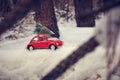 Kostanay, Kazakhstan 2022.Red Volkswagen beetle with a spruce on roof in a winter, snow covered pine forest Royalty Free Stock Photo