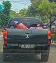 Kota Jambi, Indonesia, 3 September 2023: two men sitting in the back of a car during the dayAt Jambi City