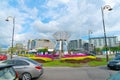 Outstanding stainless steel public art, sculpture on vehicle roundabout in Kota Kinabalu with colorful gardens and city backdrop