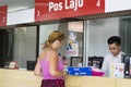 Kota Kinabalu Sabah Malaysia - August 26th, 2017 : An unidentified tourist lady being assisted by an counter staff. Pos Laju Mala