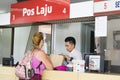 Kota Kinabalu Sabah Malaysia - August 26th, 2017 : An unidentified tourist lady being assisted by an counter staff. Pos Laju Mala